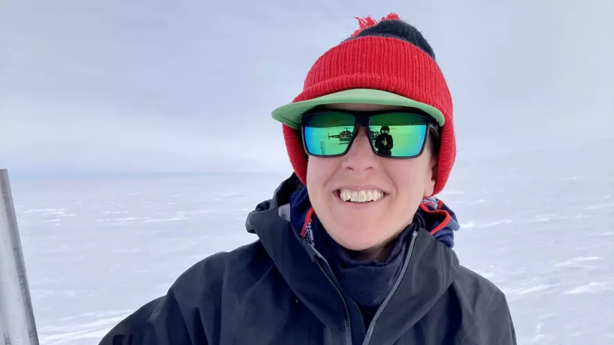 Laura with a solar panel on the Greenland Ice Sheet